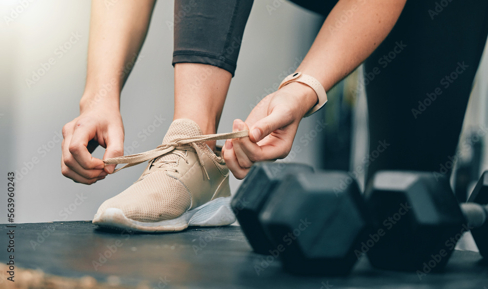 Fitness, hands or woman tie shoes lace before start of dumbbell exercise, gym training or sports wor