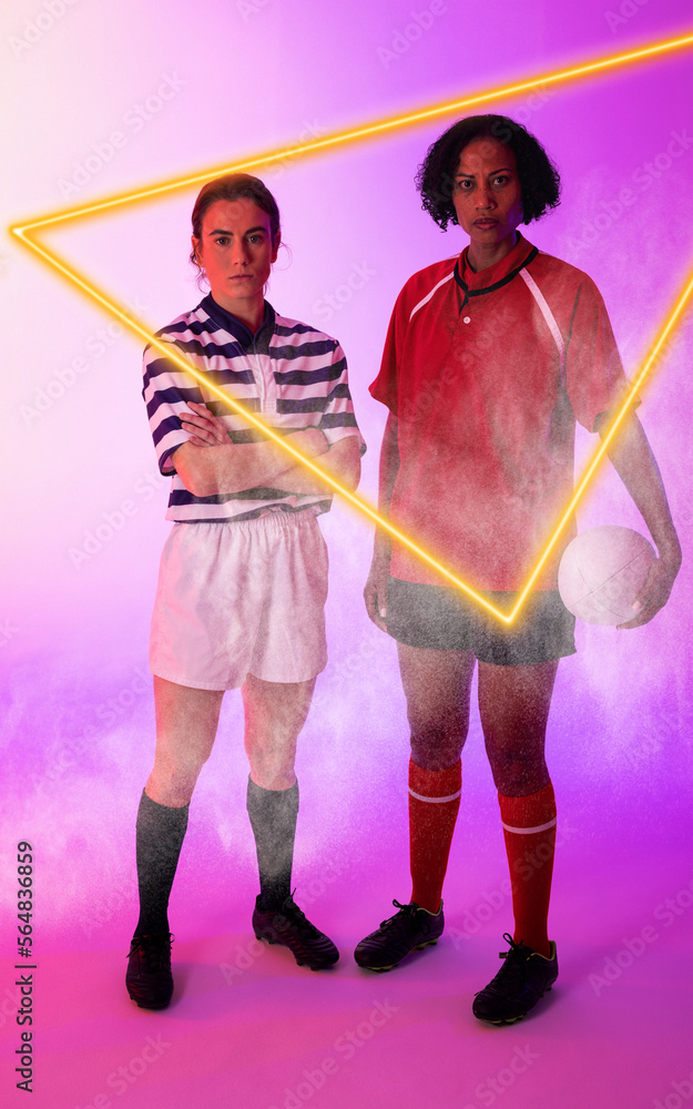 Illuminated triangle over multiracial female rugby players with ball standing on purple background
