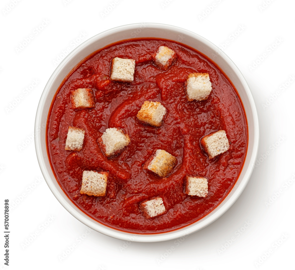 Tomato soup with croutons isolated on white background, top view