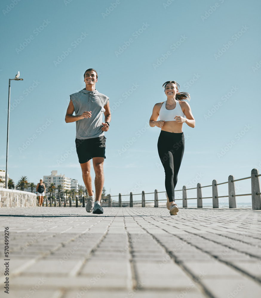 Couple, fitness and running by beach in the city for exercise, workout or cardio routine together. H