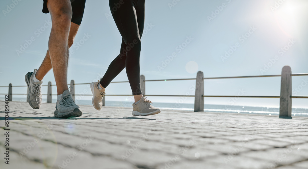 People, legs and running at the beach for exercise, cardio workout or training together outdoors. Le