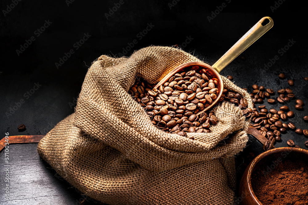 Scoop of coffee beans in a bag on dark board. Ground coffee in a cup and instant coffee in a wooden 