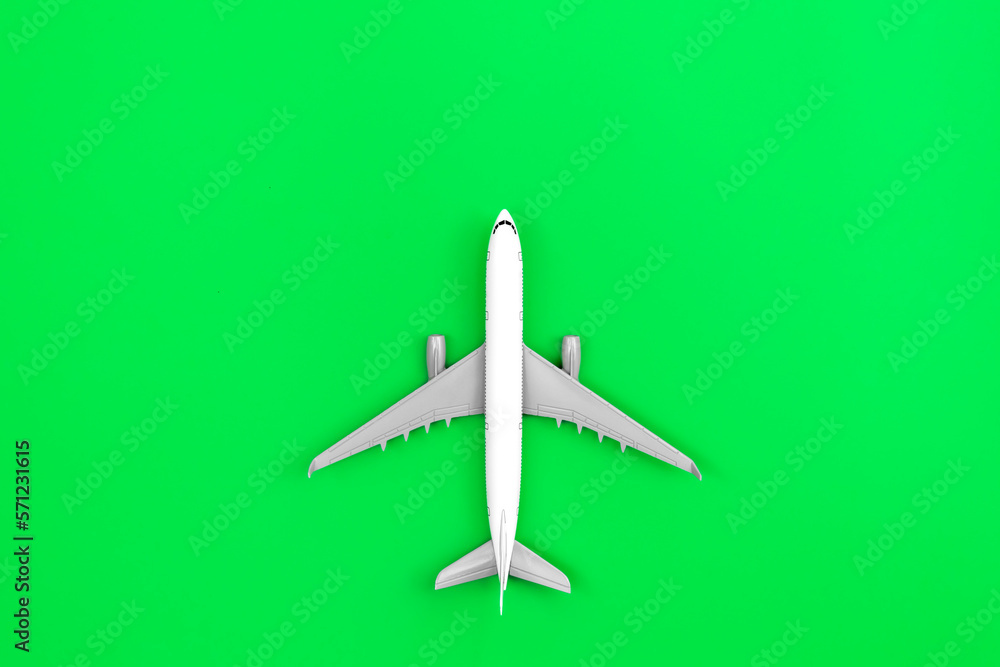 White plane, airplane on a green background, flat lay.