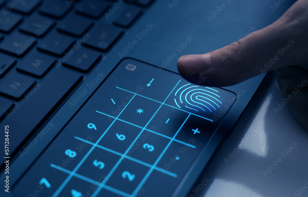 Person who uses the fingerprint to log in to the laptop. Biometrics security and innovation technolo
