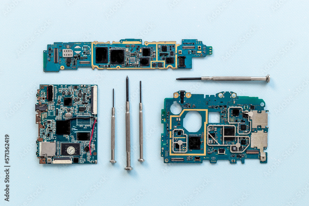 Electronics circuit board with microchips and tools, top view