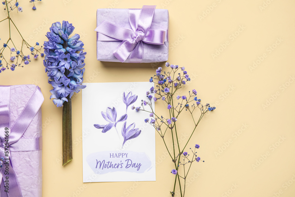 Composition with greeting card, beautiful flowers and gifts for Mothers day celebration on color ba