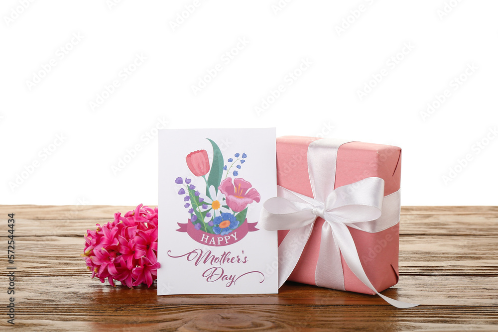 Greeting card with text HAPPY MOTHERS DAY, hyacinth flower and gift on table against white backgrou