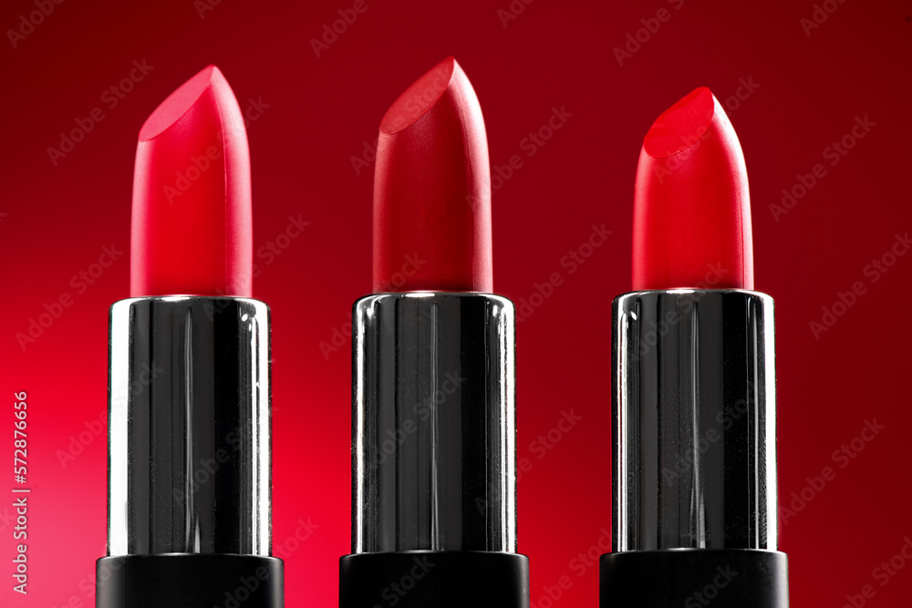 Lipstick. Fashion red Colorful Lipsticks over red background. Red lipstick tints palette, Profession