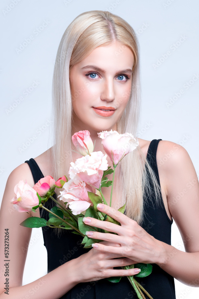 Closeup young personable woman with natural makeup and healthy soft skin holding rose for beauty car