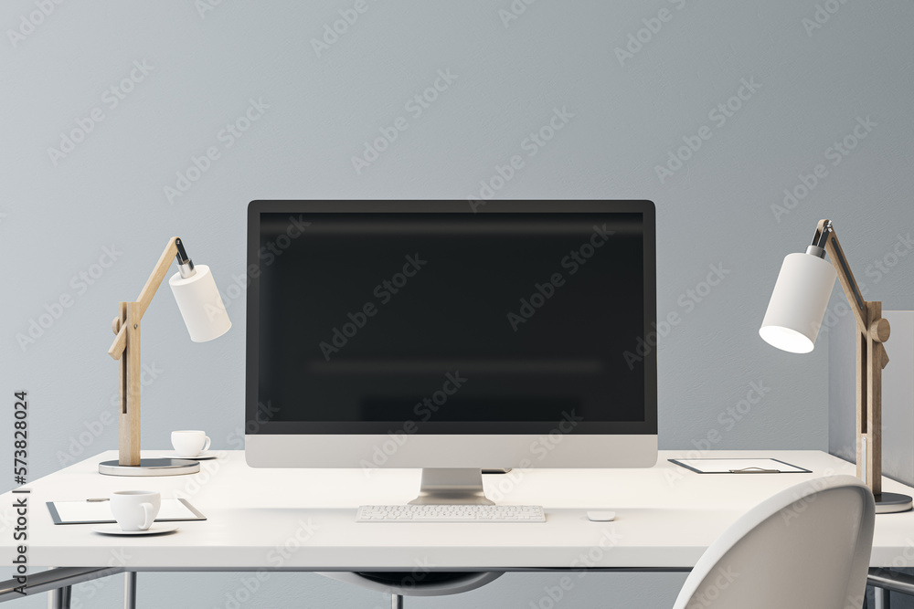 Front view on blank black modern computer screen with place for your logo or text on white work tabl