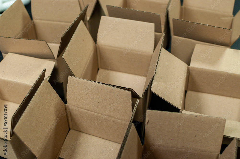 Open cardboard beige paper boxes intended for sending goods by courier or post.