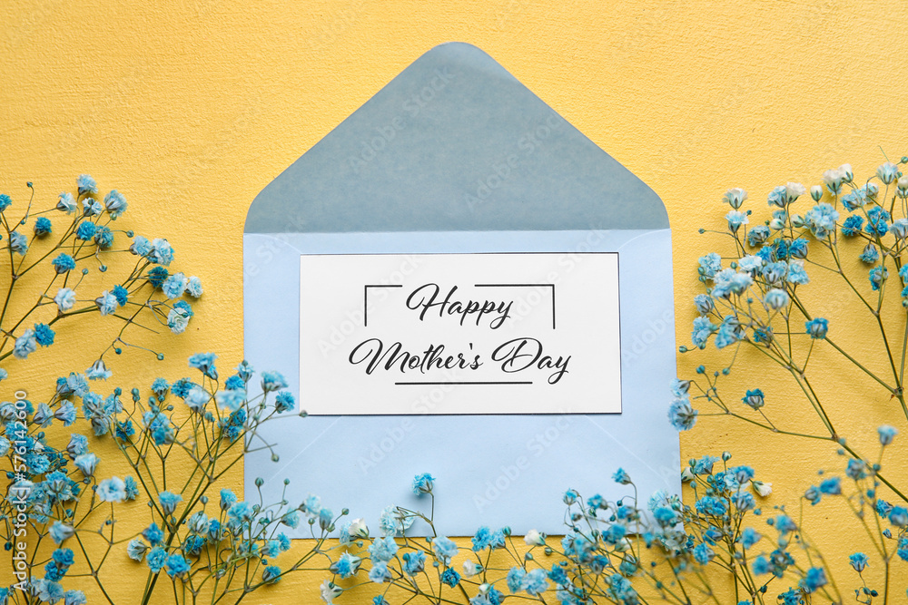 Card with text HAPPY MOTHERS DAY, envelope and beautiful gypsophila flowers on yellow background, c