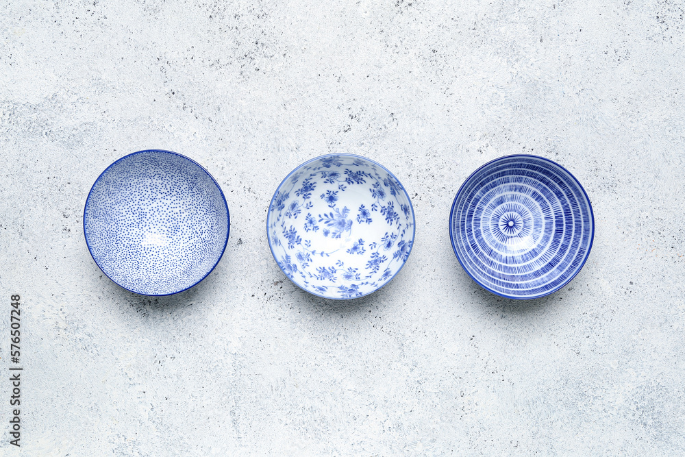 Set of different ceramic bowls on white background