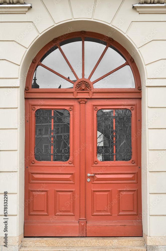 View of old building with red wooden door