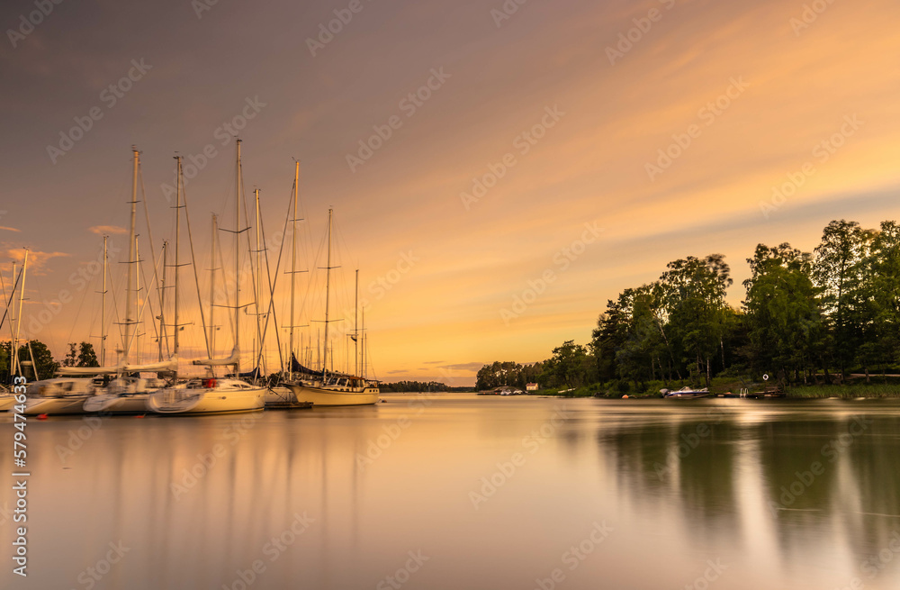 Amazing sunset over the harbor in Finland. A landscape with sunset ,boats in the harbor and an amazi