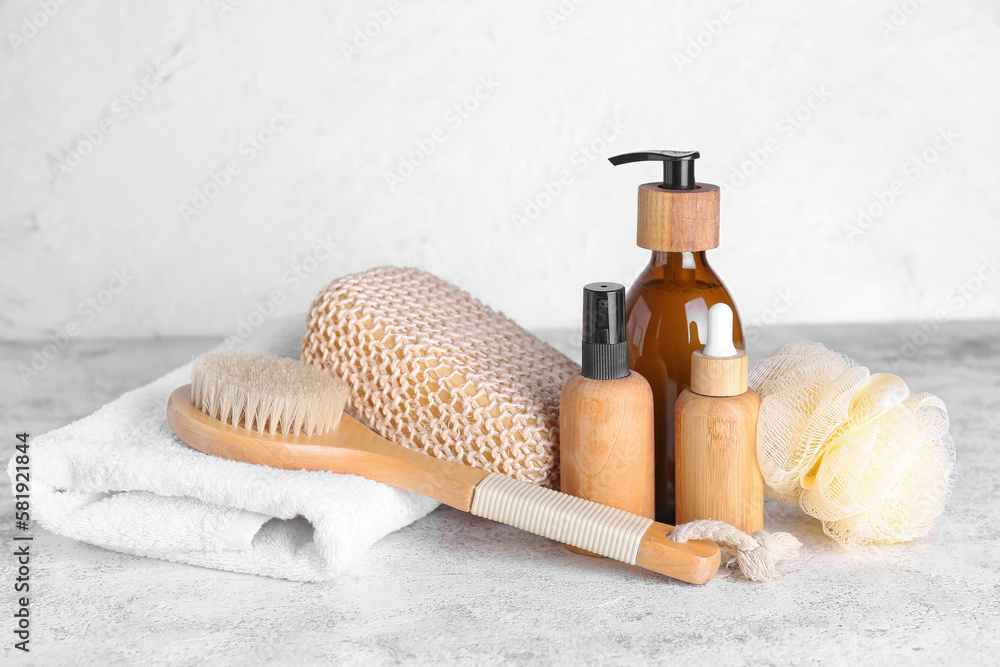 Set of cosmetic products and bath supplies on light background
