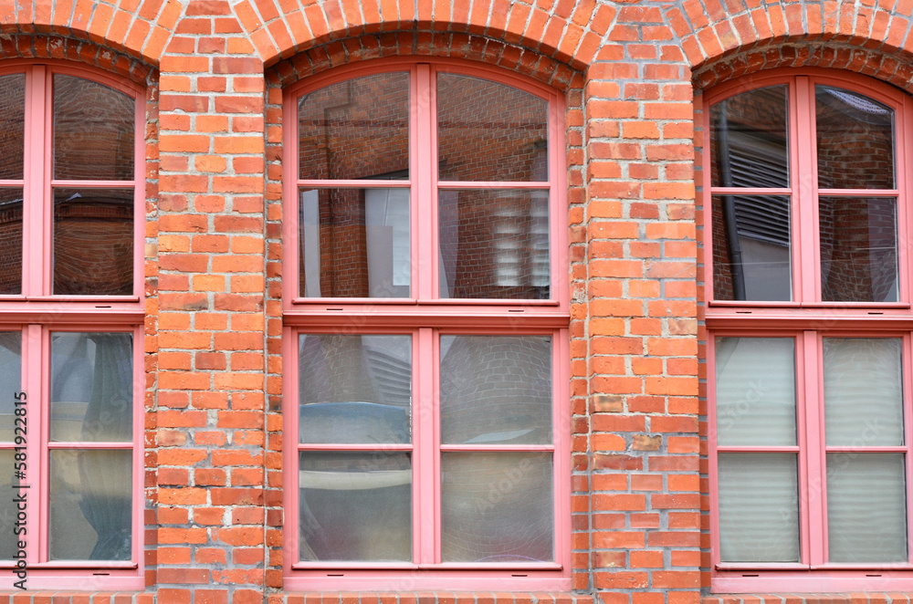 View of brick building with pink wooden windows