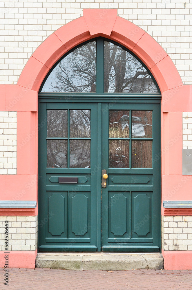 View of brick building with green wooden door