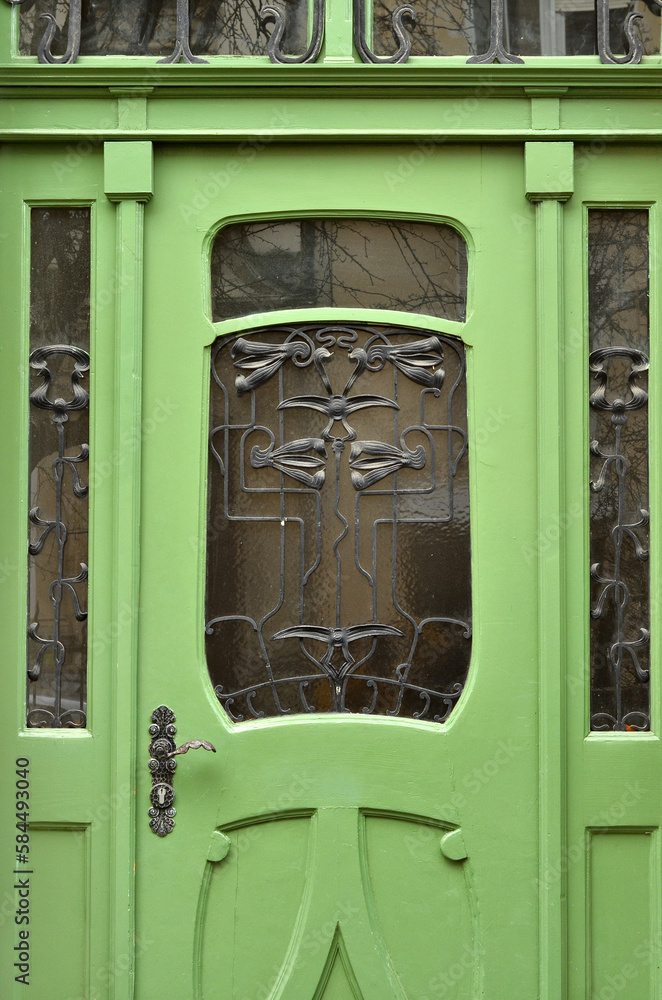 View of green wooden door in city