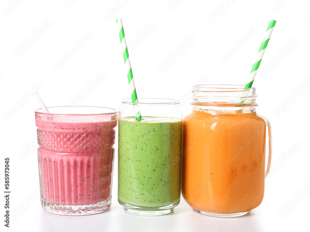 Glasses of different tasty smoothie with straws on white background