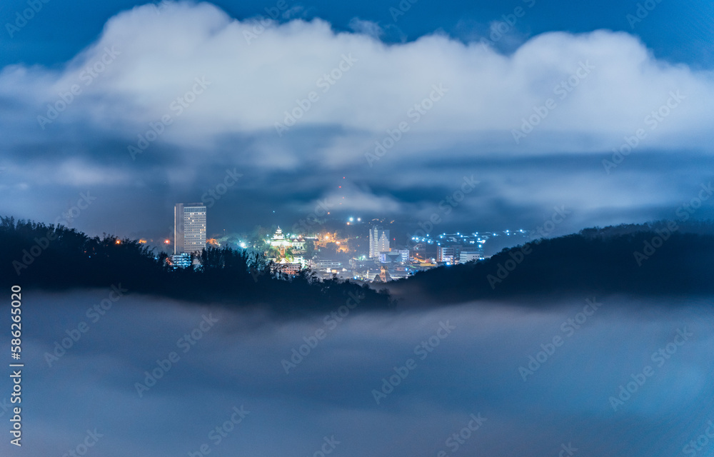 Aerial view of Betong city skyscraper view through misty mountain, Yala, Thailand