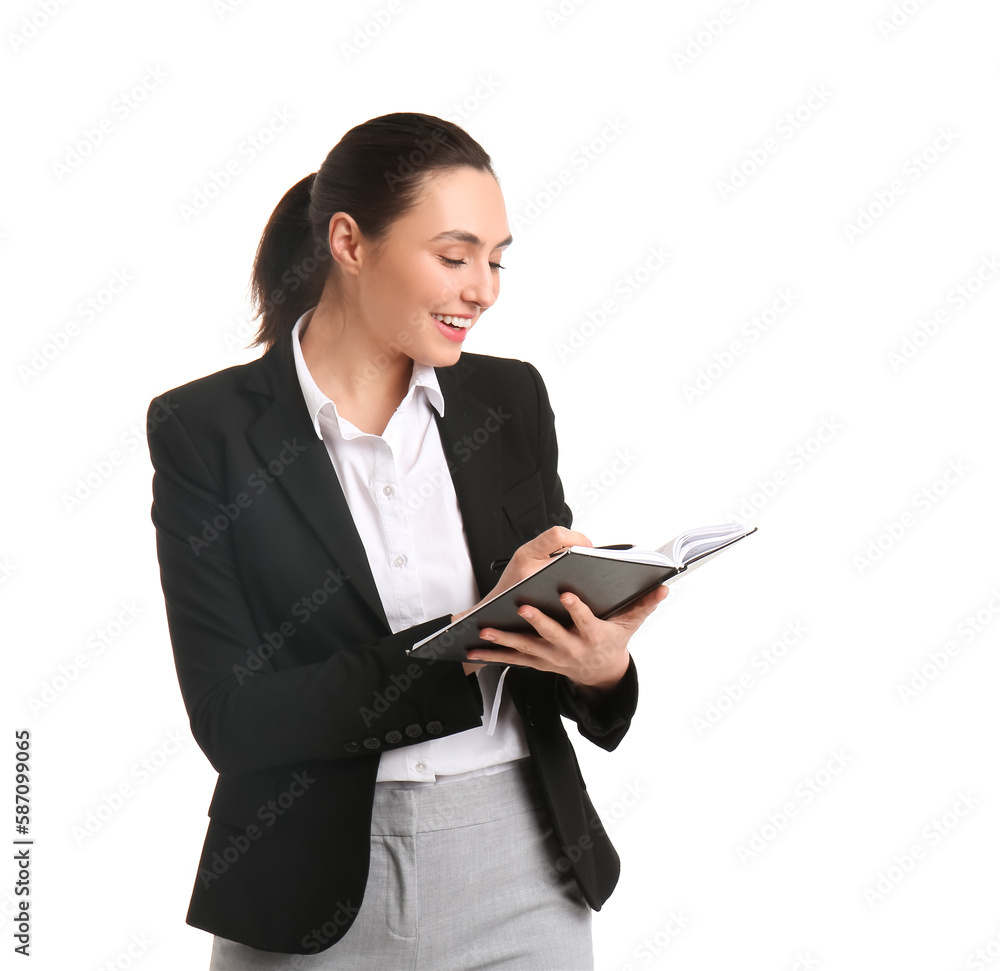 Female business consultant writing in notebook on white background