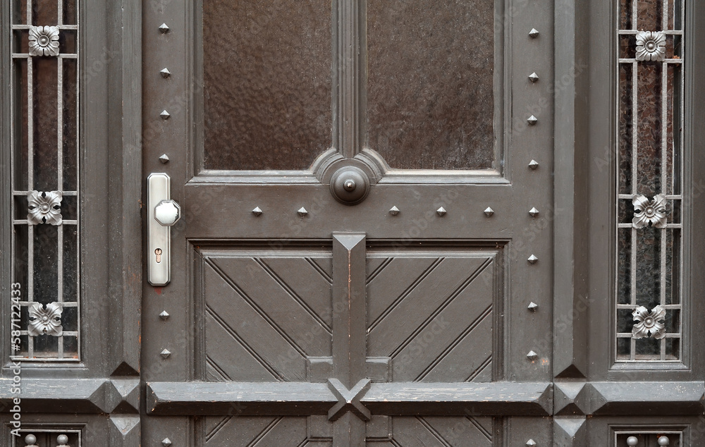 View of black wooden door in city, closeup