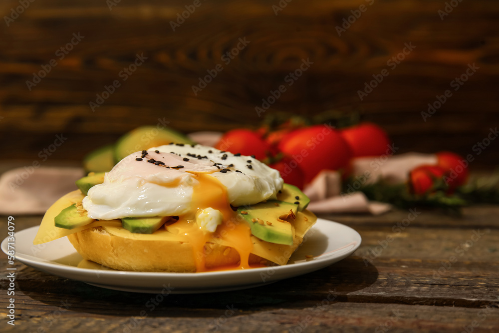 Plate with tasty egg Benedict on wooden background, closeup