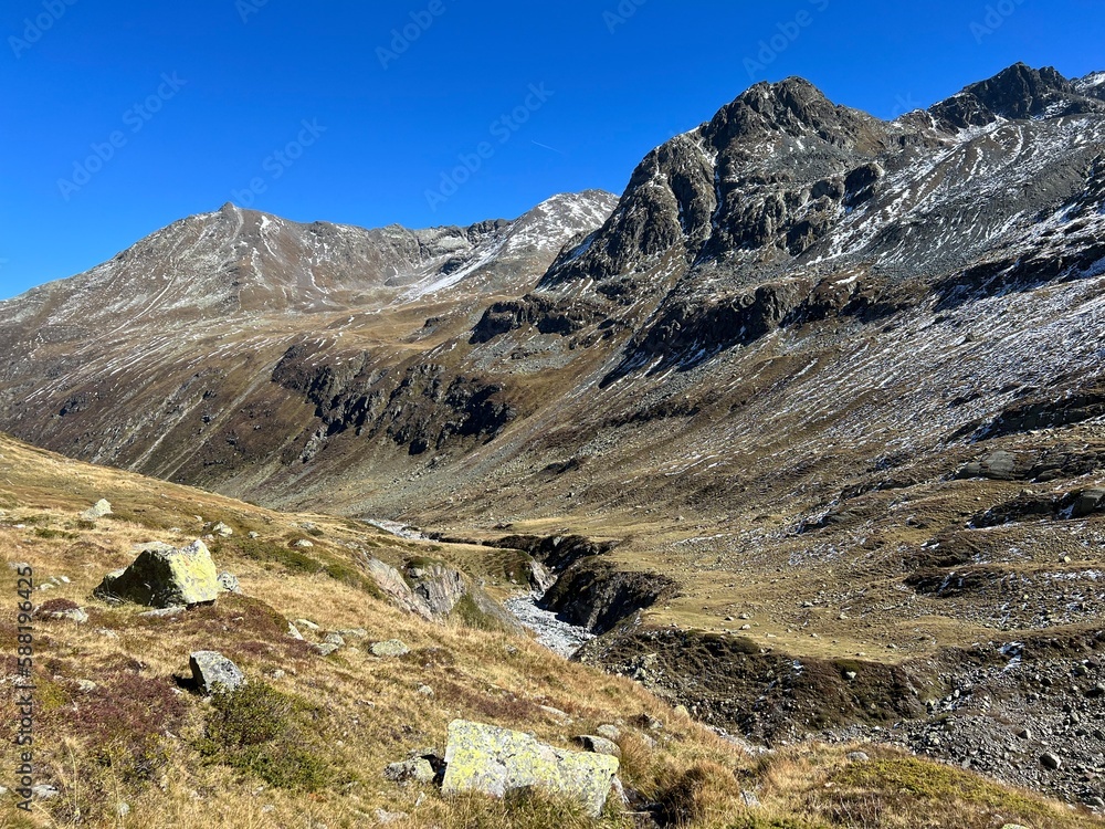 Beautiful autumn panorama of the alpine valley Val Grialetsch and the stream Aua da Grialetsch in th