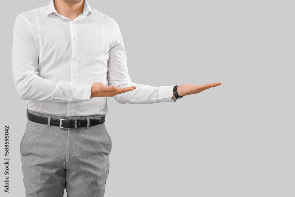 Business consultant showing something on grey background