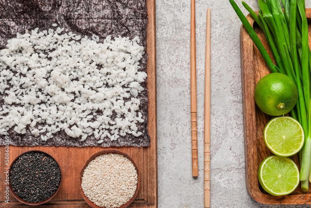 Nori with rice and sesame seeds on light background