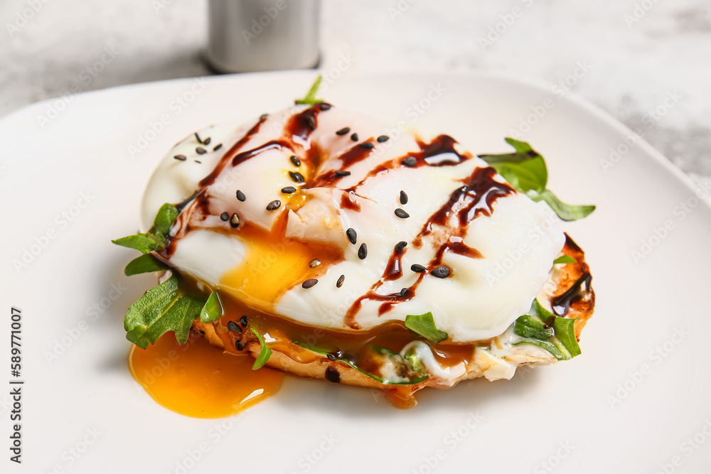 Plate with delicious egg Benedict on white table, closeup