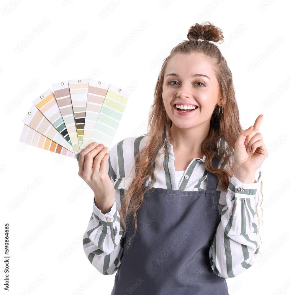 Female artist with paint color palettes pointing at something on white background
