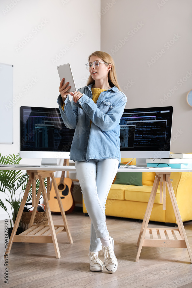 Female programmer working with tablet computer in office