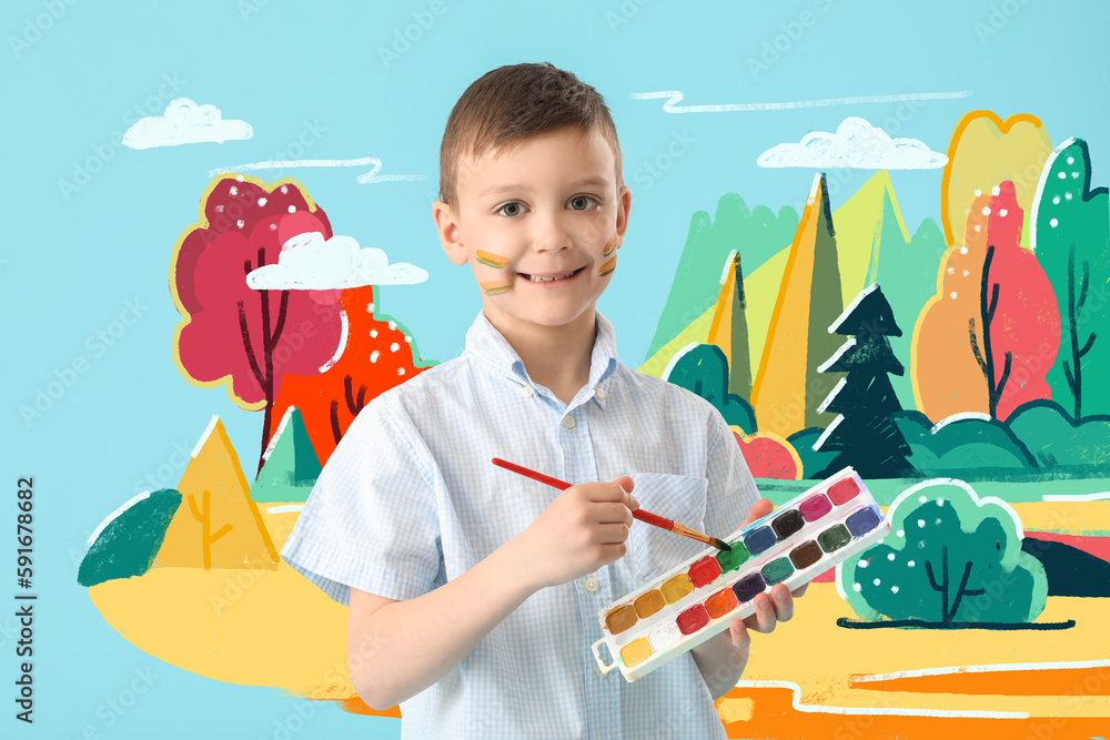 Cute little boy painting picture on light blue wall