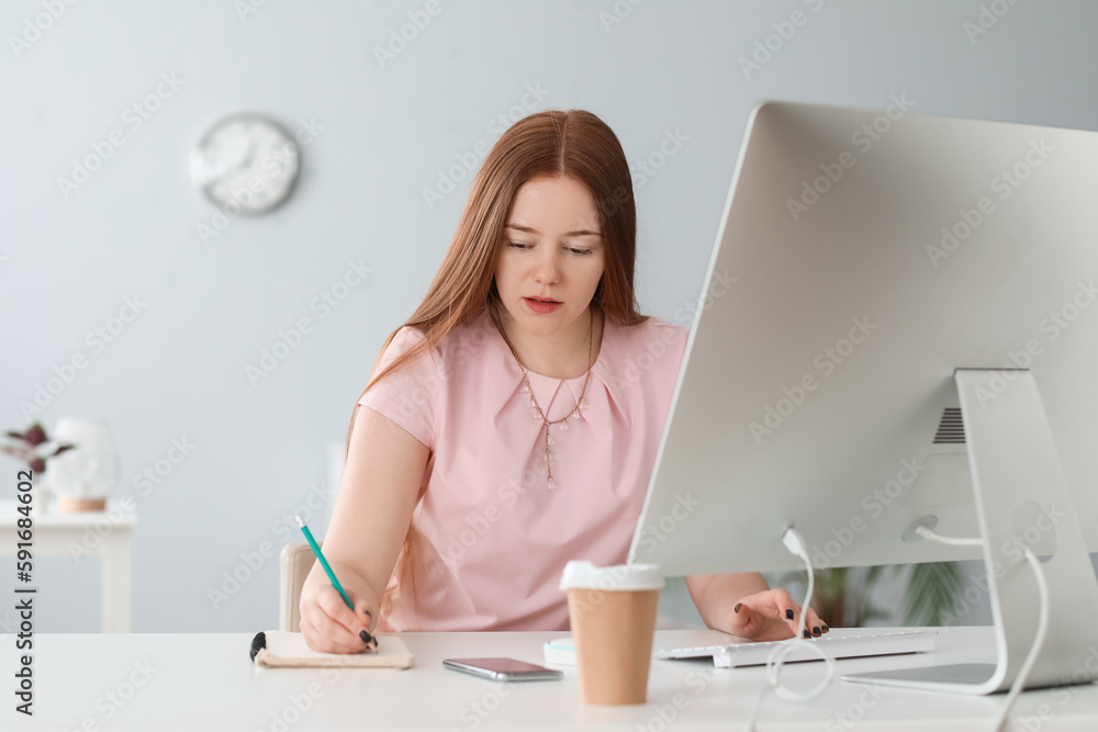 Female programmer working at table in office