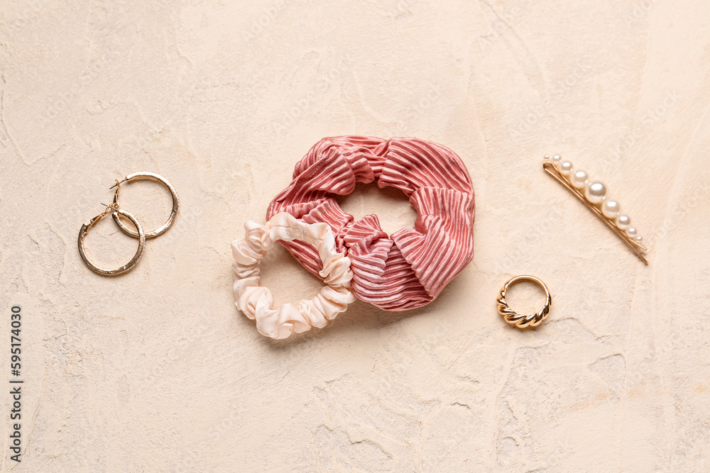 Set of female accessories with scrunchies on light background