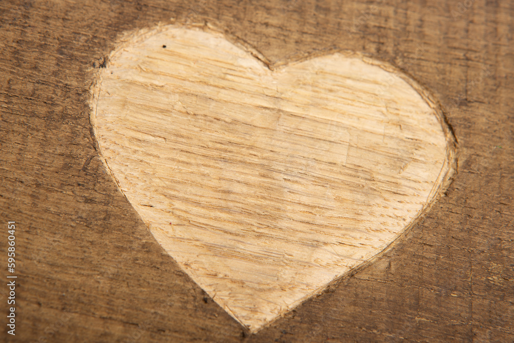 Valentines Day greetings concept. Heart shape carved on the wood. Valentines greeting card. Free sp