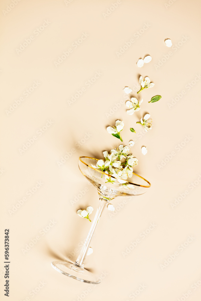 Champagne glass and spring flowers flat lay