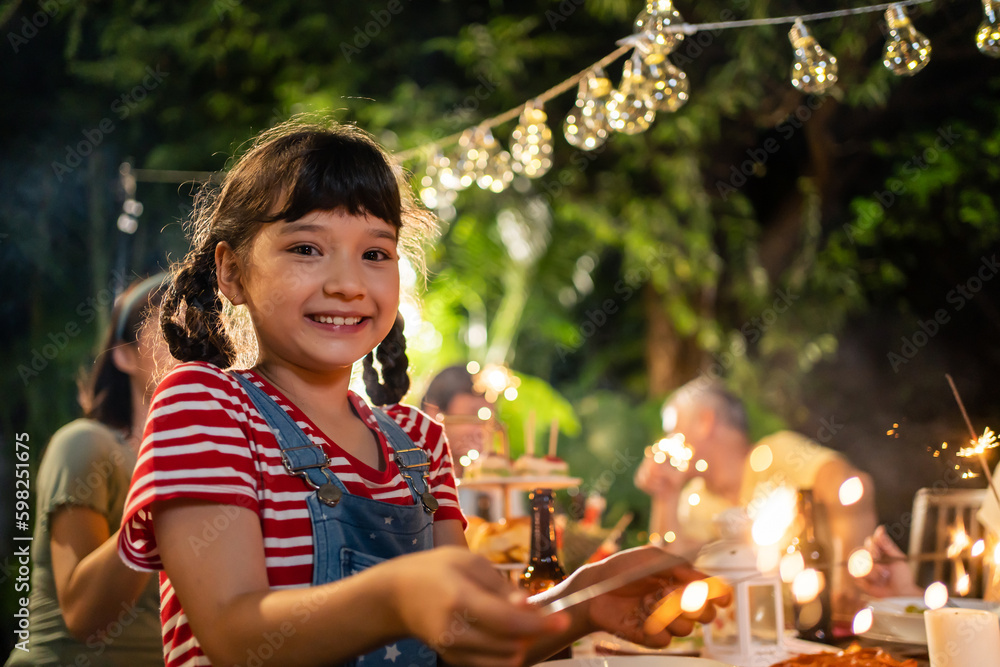 Portrait of young child looking at camera while having party outdoor. 