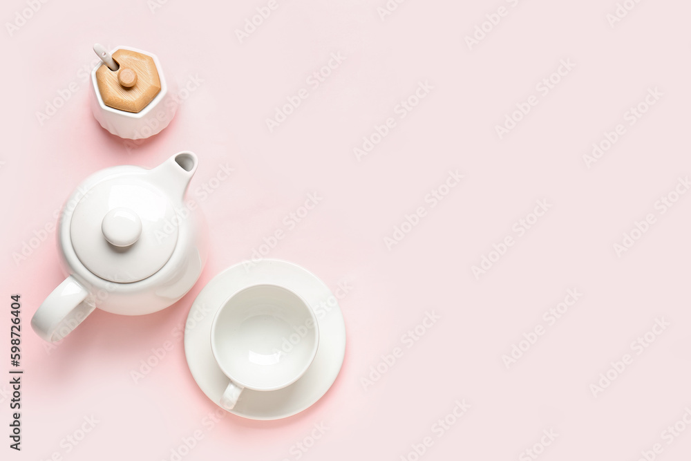 Teapot, cup and sugar bowl on pink background