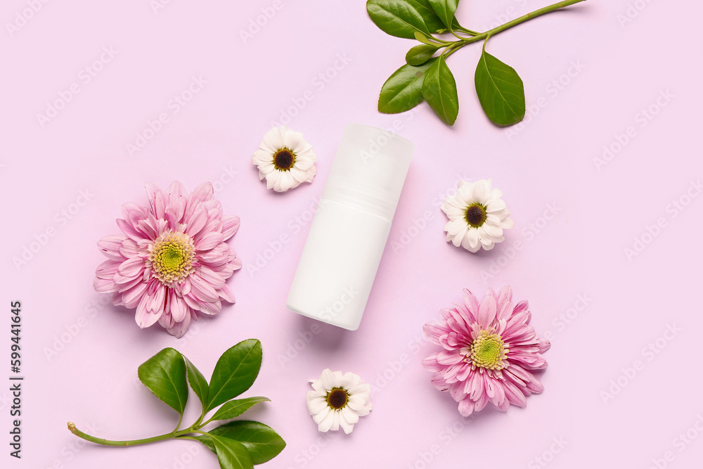 Deodorant with flowers and leaves on pink background