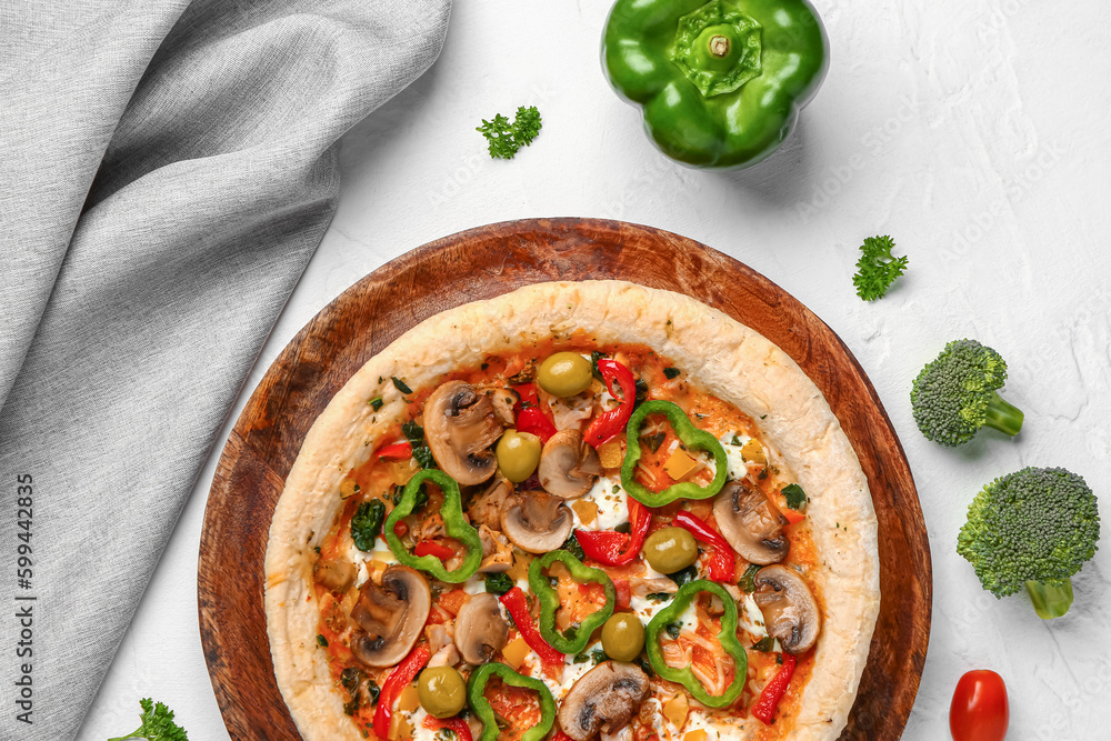 Board with vegetable pizza and ingredients on white background