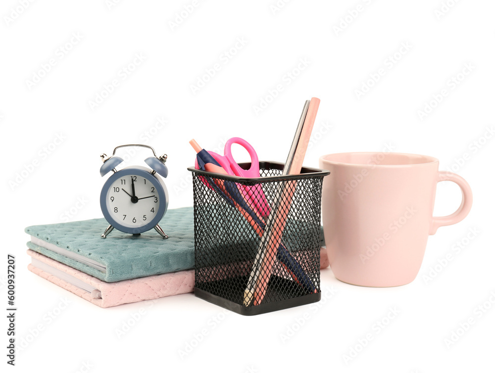 Holder with stationery, notebooks and alarm clock isolated on white background