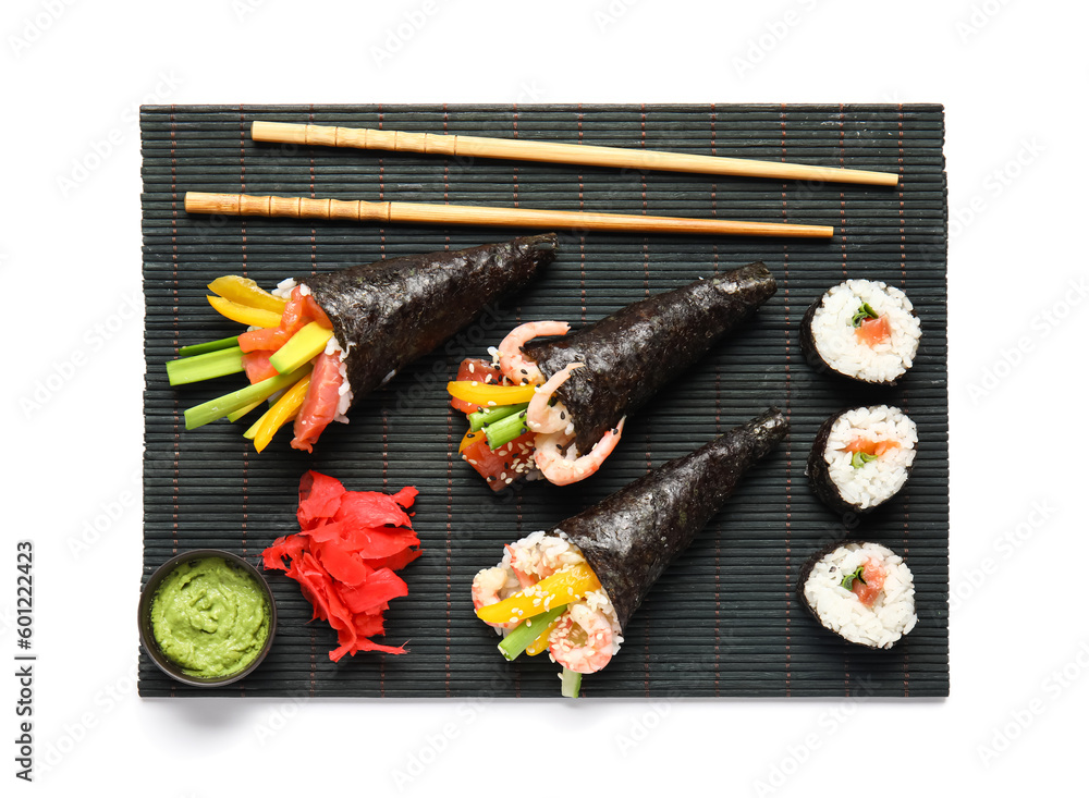Bamboo mat with tasty sushi cones, ginger and wasabi on white background