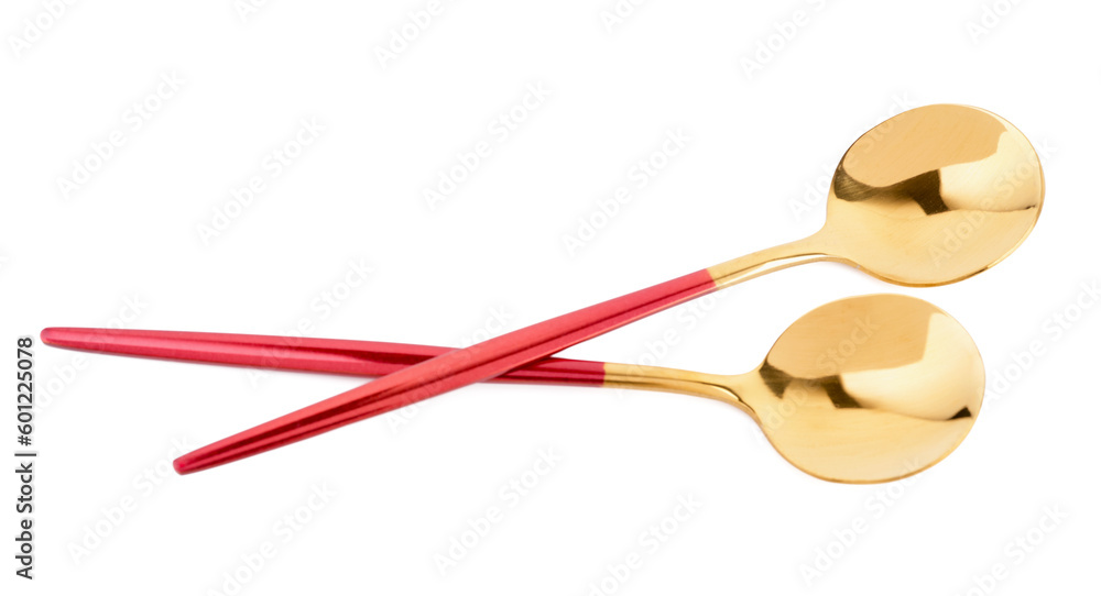 Golden spoons with red handles on white background