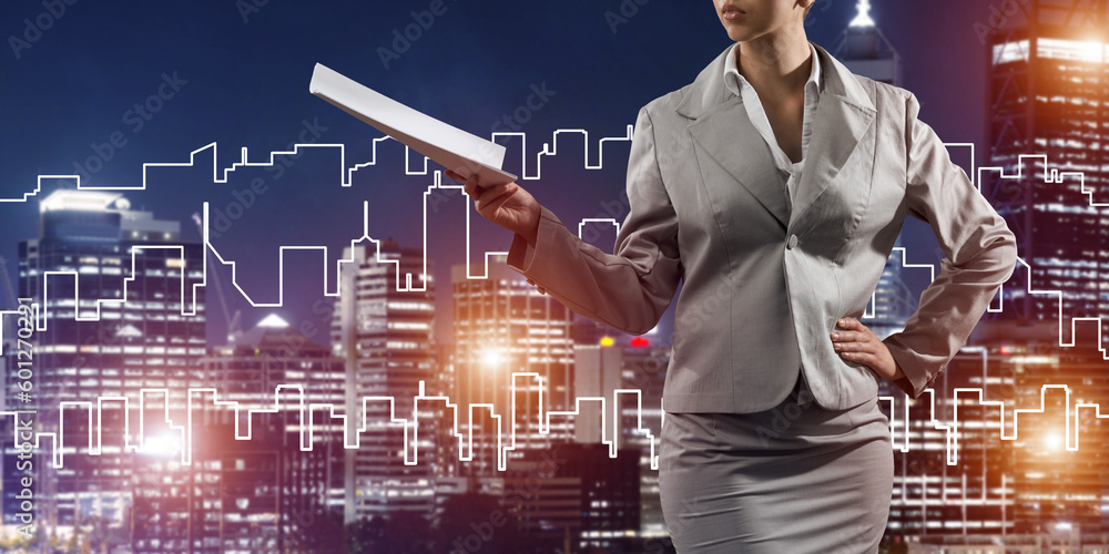Woman architect or engineer presenting construction concept and holding documents in hand