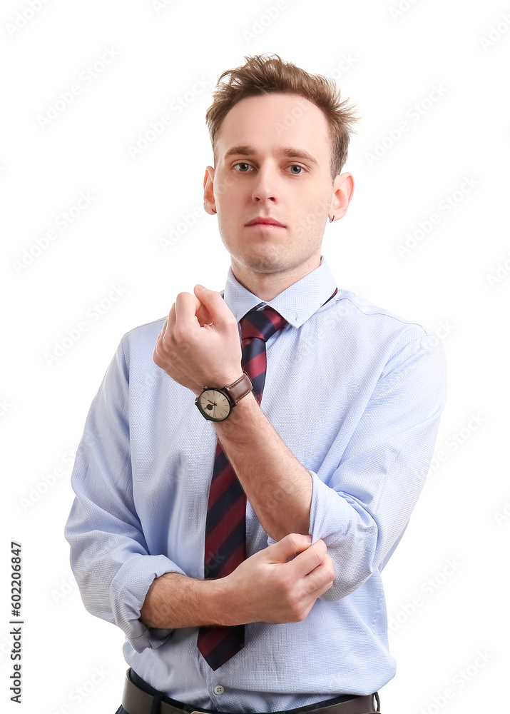 Young businessman rolling up his sleeve on white background