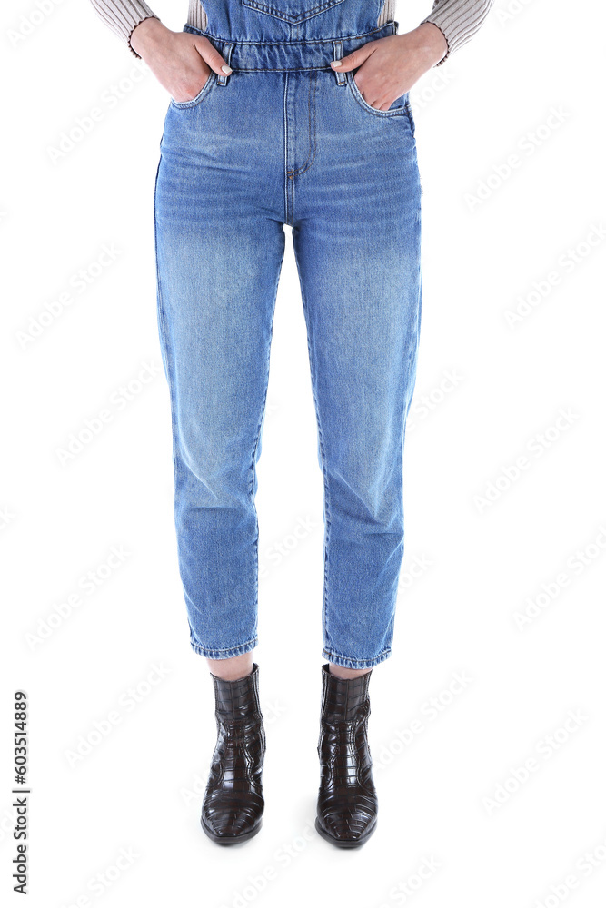 Young woman in denim jumpsuit on white background