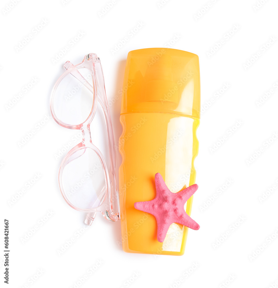 Bottle of sunscreen cream with sunglasses and starfish isolated on white background